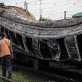 25日、ウクライナ東部ドニエプロペトロフスク州チャプリネの駅で、ロシアのミサイル攻撃で焼けた車両（ゲッティ＝共同）