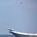 中国海軍の空母「遼寧」から発艦する戦闘機とヘリコプター（防衛省統合幕僚監部提供）